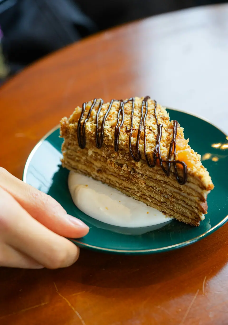Slice of layered honey cake on a plate (stock photo)