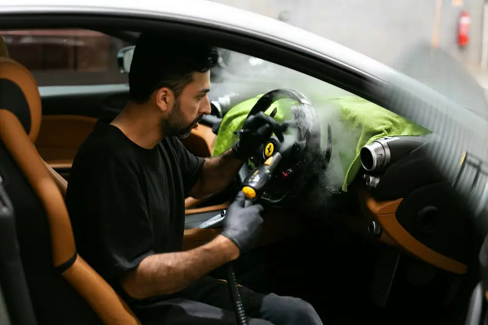 Steam cleaning a car interior (stock photo)