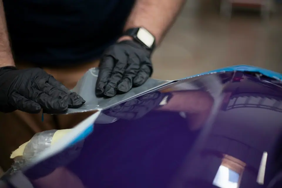 Protective film being applied to a car panel (stock photo)