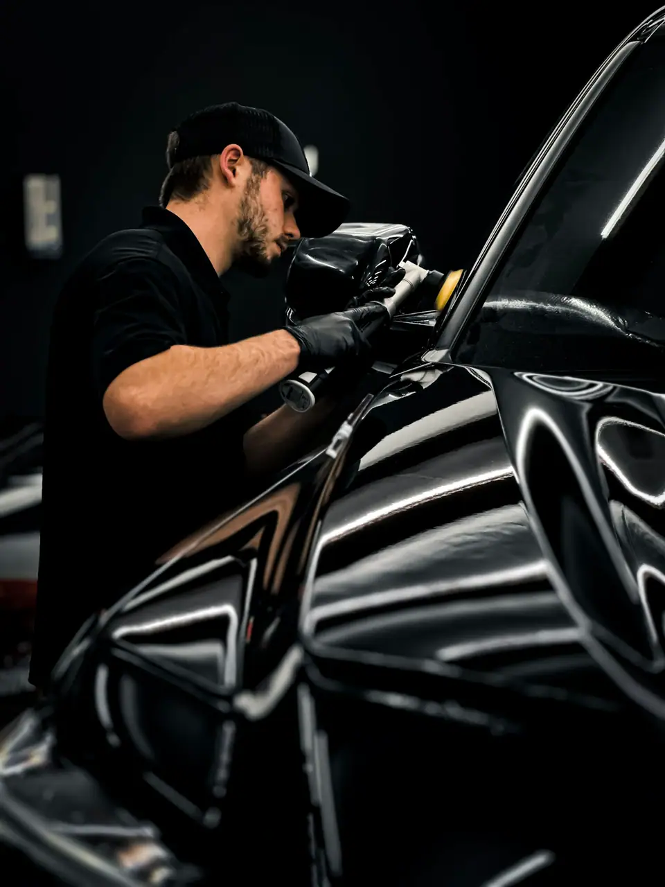 Waxing a car in a garage (stock photo)